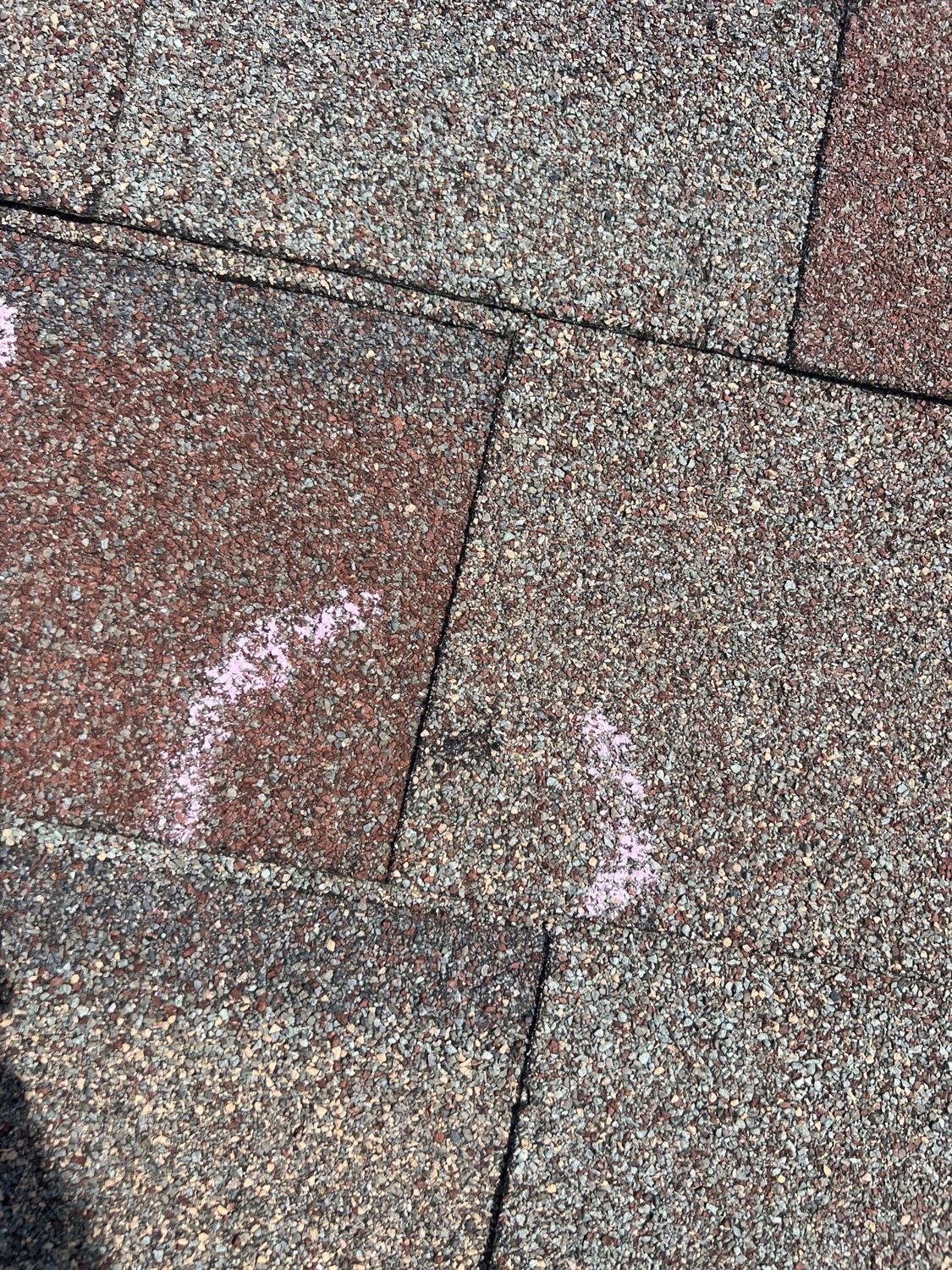 Hail-damaged shingles chalk-marked during an insurance inspection in the Springfield, MO area